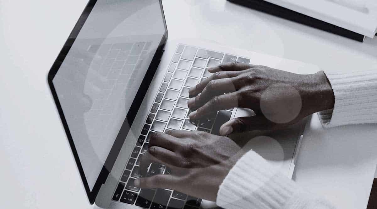 Man writing on a laptop